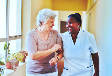 caregiver and elder woman smiling