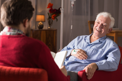 nurse assisting senior men with senile dementia