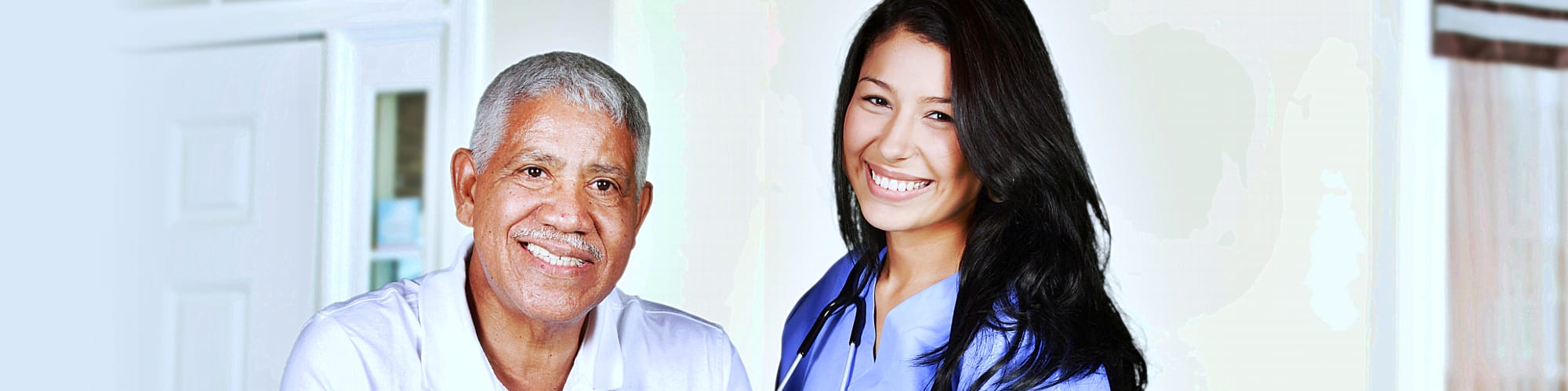 senior man and caregiver smiling