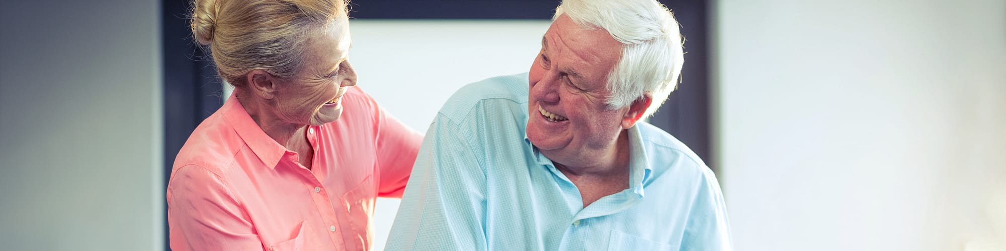 caregiver and senior man smiling